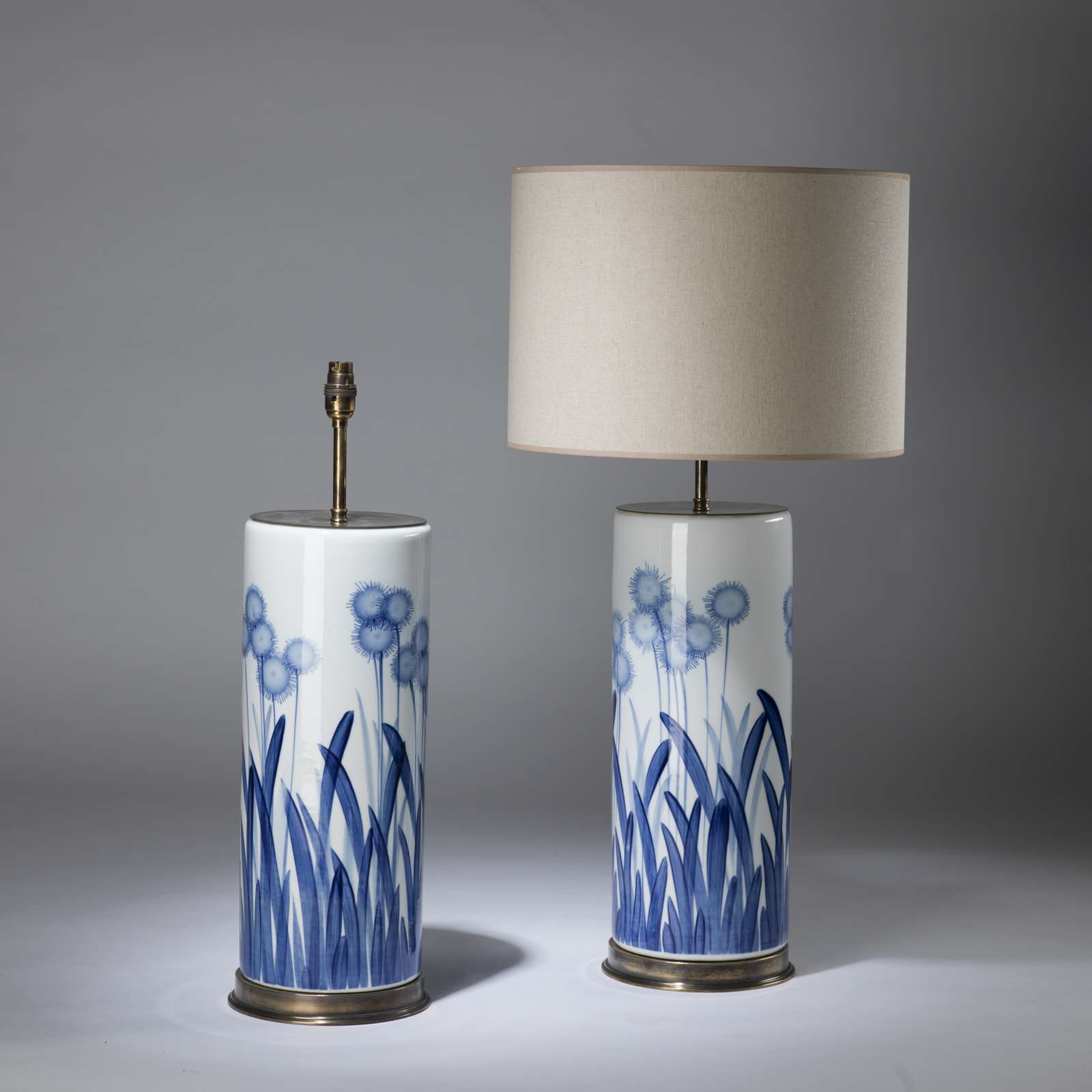 Pair of large blue and white meadow lamps on round brass bases (T4339