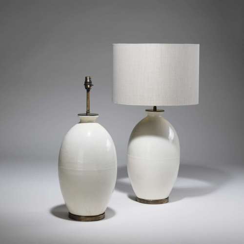 Pair Of Medium Cream Ceramic Lamps On Distressed Brass Bases