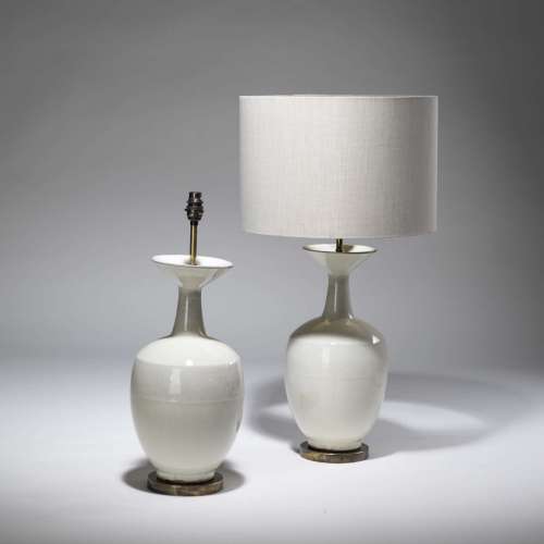 Pair Of Medium Cream Ceramic Lamps On Distressed Brass Bases