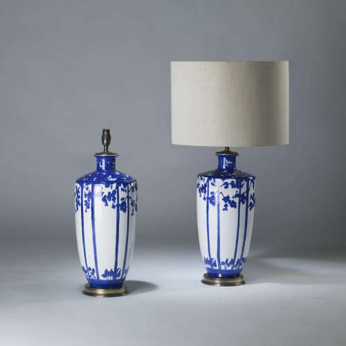 Pair Of Medium Ink Blue And White Ceramic Tree Lamps On Round Brass Bases